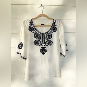 White tunic top from France with navy embroidered detailing. Size small